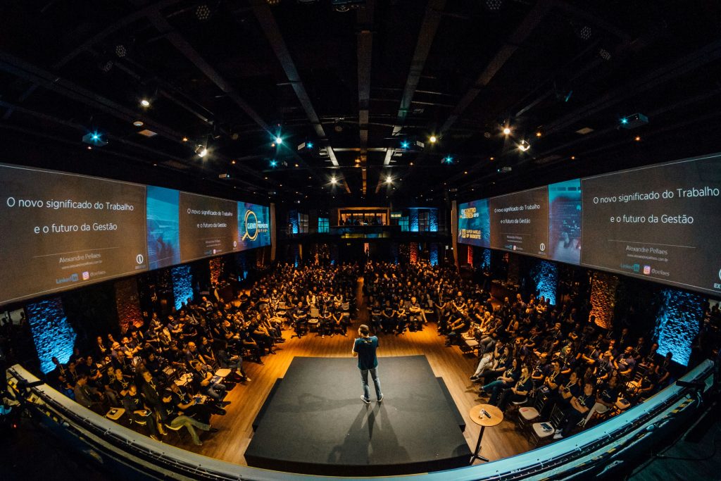 Conference room full of people attending a talk