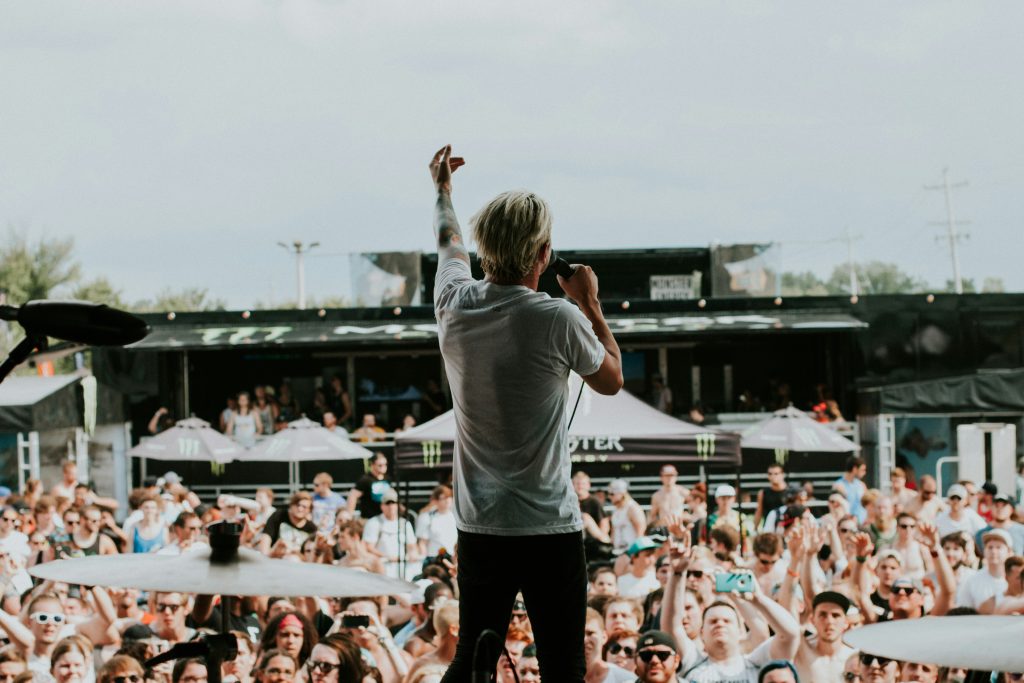 Small outdoor concert with cheering crowd