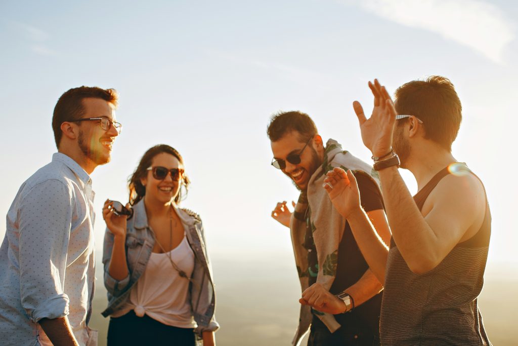 4 people enjoying a summer evening at a festival