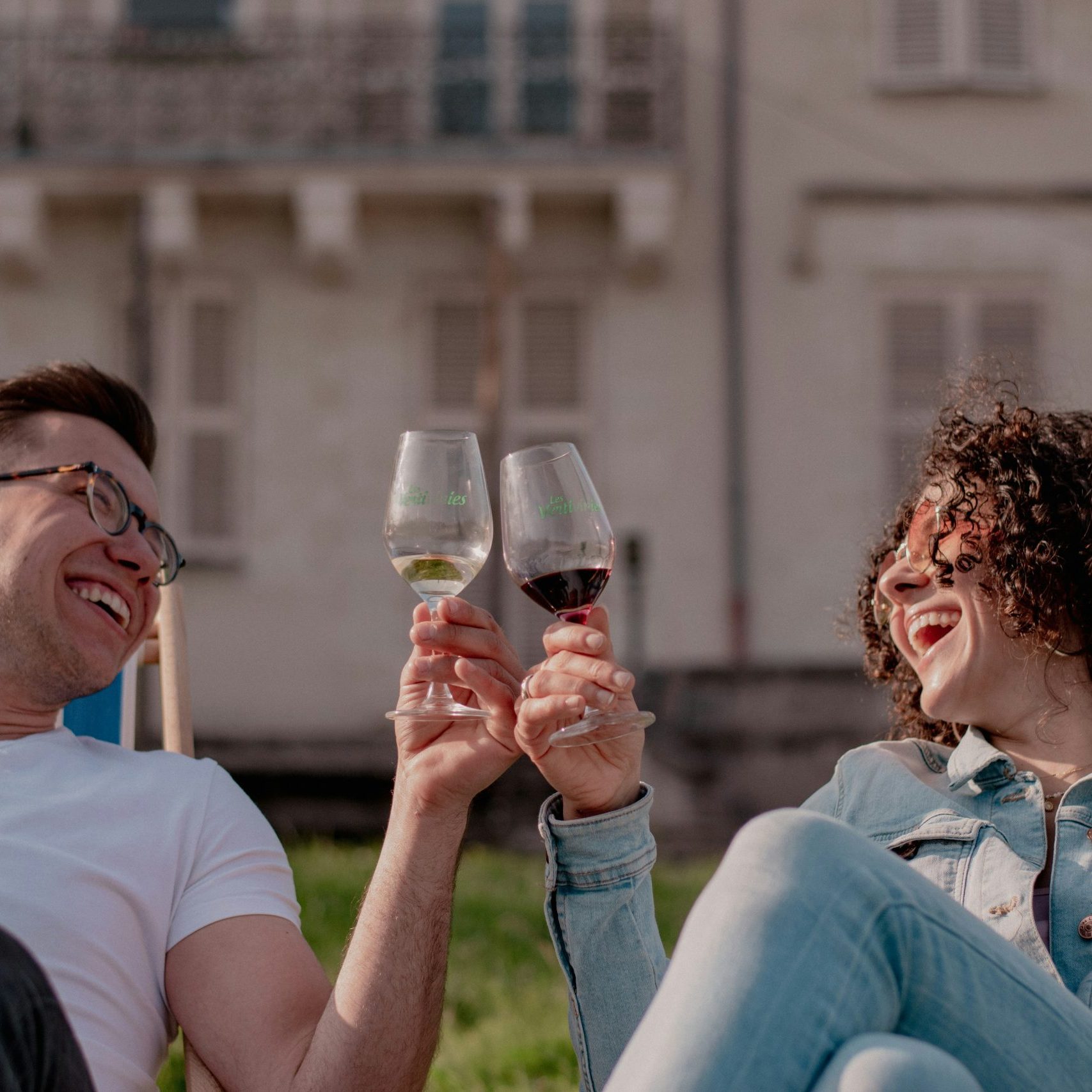 Couple on deck chairs drinking wine